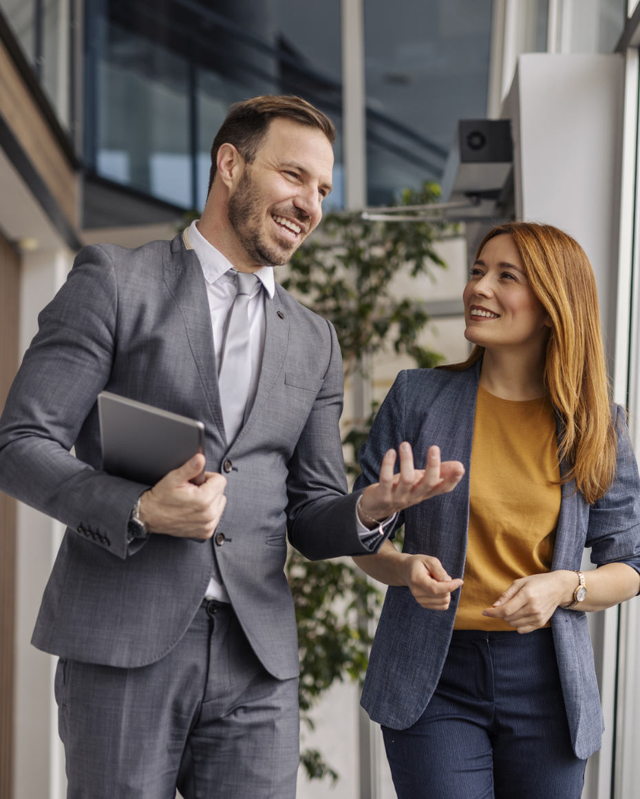 Happy business professionals walking and smiling. 